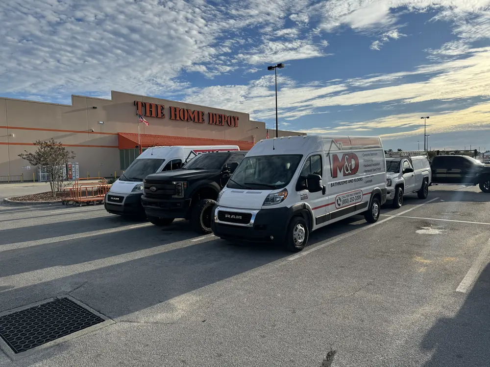 M&D vans and trucks parked outside a building supply store