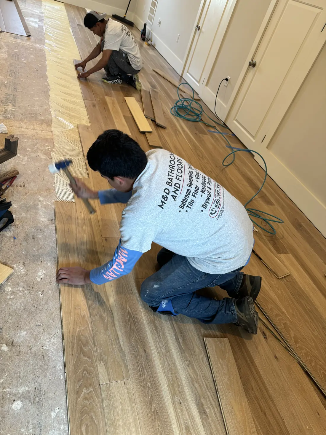 M&D team members installing hardwood flooring